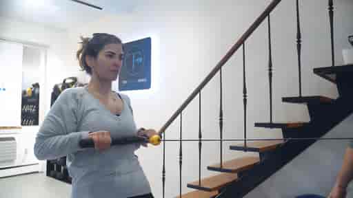 Antonietta doing cable rows in a private gym studio.