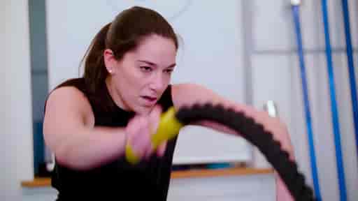 Lindsey using heavy ropes in a private gym studio.